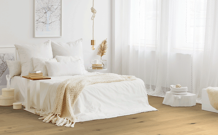 hardwood flooring in bedroom with sheer curtains